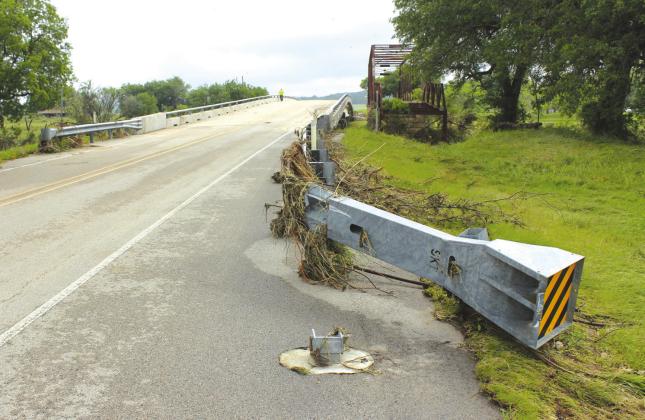 Nathan Diebenow | Meridian Tribune A metal guardrail on FM 3112 is bent due to floodwaters from the Bosque River through Clifton City Park on Sunday, May 5. This bridge is open to traffic, but roadwork is still on-going on Highway 6 between Clifton and Valley Mills.