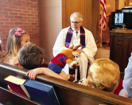 Rev. Clint Schofield (center) recently held one of his last children’s sermons prior to retiring from First Presbyterian Church in Clifton. Courtesy Photo By Bryan Davis