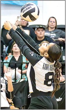 Photos by Wendy Orozco courtesy of The Sports Buzz Lady Jacket Mariana Paniagua (11) attacks the ball at the net (top); Senior Hope Cabrera (8) keeps the ball in play (above).