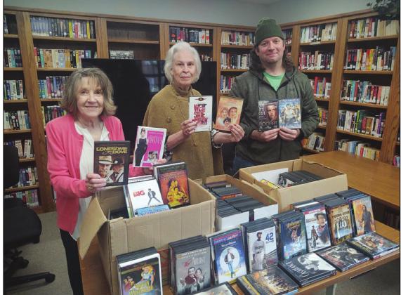 From left, Clova Gibson and Kathleen Hale with the Valley Mills Public Library are thrilled with the delivery of DVDs from Nathan Diebenow and the Bosque Film Society. Photo Courtesy of Bryan Davis