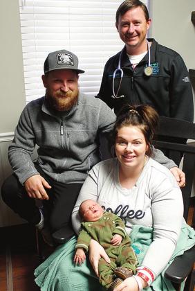 Ashley Golightly holds Bosque County’s first baby of 2022, Huxyn Beau Golightly with proud father Michael Golightly (left) and delivering physician Dr. Lance Robinson. Courtesy Photo