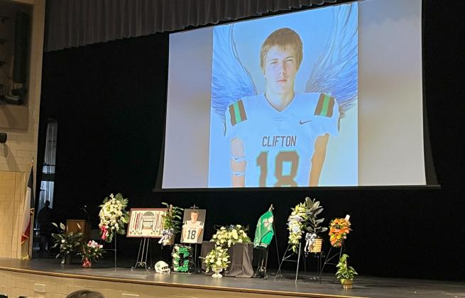 Flowers, pictures, and sports memorabilia of the late Clifton High School student Dylan Clay Atkins grace the stage at Clifton ISD’s Performing Arts Center for his memorial service on Saturday morning February 10, 2024. 