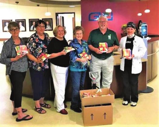 From left, Clifton Civic Improvement Society members Elaine Brown, Nancy Kleibrink, president Pat Mitchell, and BIT program chair Shirley Dahl, with Nellie Pederson Civic Librarian Lewis Stansell, present 50 book bundle sets to Goodall-Witcher Hospital OB/GYN Nurse Supervisor Cassandra Cox. After the 50 bundles are used, the CCIS and the Library will provide additional bundles. Courtesy Photo