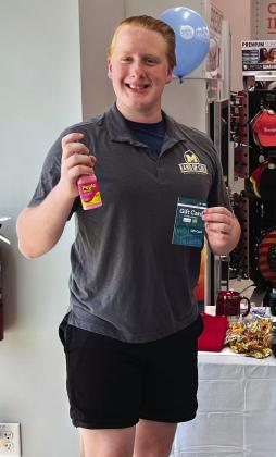 Caleb Cummings of Meridian shows off his trophies –a bottle of heartburn medicine and a gift card– won by eating seven chimichangas during the Allsup’s convenience store’s grand opening on Thursday, July 27, in Meridian. Nathan Diebenow | Meridian Tribune