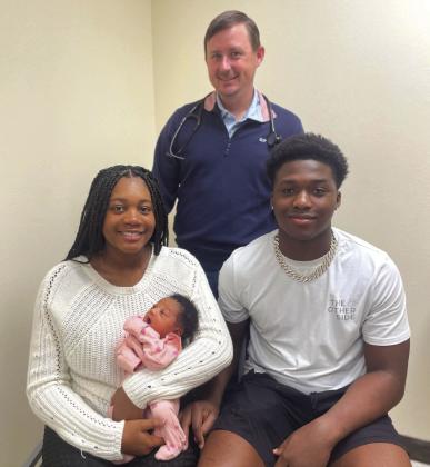Goodall-Witcher Healthcare welcomed the first baby of the new year. On Thursday, January 4, 2024, Za’Niyah Lynnette Wood (front) of mother Kayden Mclennan (middle, left) and father Darrell Wood (middle, right) was delivered by Dr. Lance Robinson (back). Courtesy Photo By Goodall-Witcher