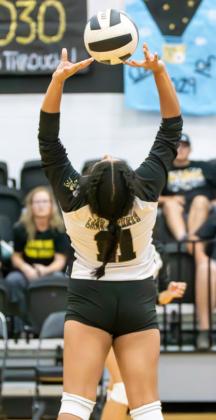 Photos by Wendy Orozco courtesy of The Sports Buzz Lady Jacket senior Eve Dirkse (10) prepares to serve (top); junior Mariana Paniagua (11) puts up a set for a teammate’s attack attempt (above).