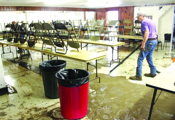 Nathan Diebenow | Meridian Tribune Using a wet-dry vacuum, Tom Godby removes mud left over by flood waters in the American Legion Post in Clifton City Park on Monday morning, May 6.