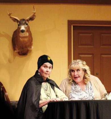 Played by JoAnn Grelle and Debbie Rollins (from left), sisters Regan Tasker and Connie Girard prepare for a seance during TBT's'The Clock Struck One.' Nathan Diebenow | The Clifton Record