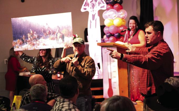 At the 20th anniversary Hollywood-themed celebration of the Bosque Animal Rescue Kennels, Inc., Talon Clift (front, from right) and his father Todd assist the live auction with BARK President Laura Bush (back, from right) and BARK Vice President Jackie Murski on Saturday, February 18, at the Tin Building Theatre at the Bosque Arts Center in Clifton. Nathan Diebenow | The Clifton Record
