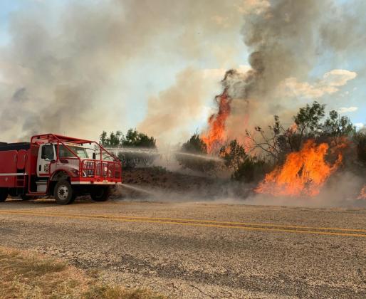 Sterling County fire engine battles fire where triple-digit temperatures soar. Photo courtesy of Texas A&amp;M Forest Service