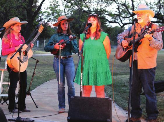 The three performing acts take the stage together during the round-robin finale of the Lomax Gathering hosted by the Bosque Museum Saturday evening at the John A. Lomax Amphitheater in Meridian. From left, Pipp Gillette, Kristyn Harris, Hailey Sandoz, Emily Wilkinson and Andy Wilkinson. Ashley Barner | Meridian Tribune