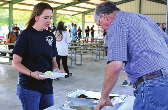 Cranfills Gap volunteer firefighter Kayla Reierson is served an expertly-cooked steak by Mike Domel at the appreciation dinner held at Bosque Bottoms in Meridian. Ashley Barner | The Clifton Record