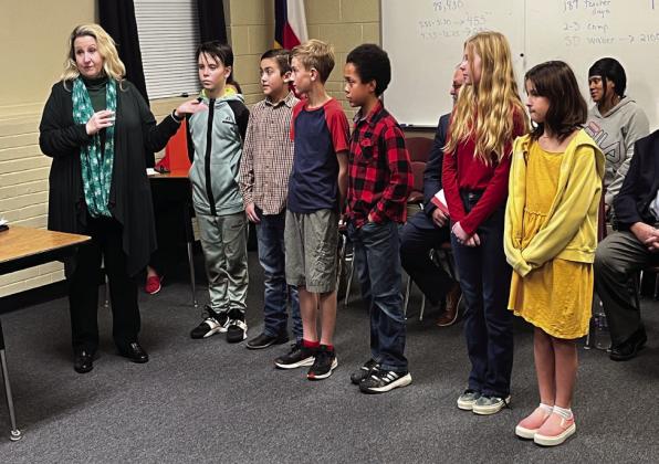 The Jacket News Network team led the Meridian ISD Board of Trustees in the Pledge of Allegiance during their meeting on Monday, December 12. MES Principal Jaime Leinhauser ((from left then introduced the news team, who consists of Raymond Ahrns, Cylan Hightower, Parker Hurley, Nolan Davenport, Sophie Richardson, and Sadie Yants. Nathan Diebenow | Meridian Tribune