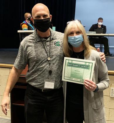 Clifton Middle School English teacher, Vikki Moore, right, is presented with a staff member of the month certificate by Clifton Middle School Principal Michael Kusler.