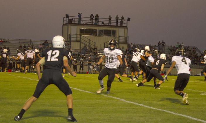 Below Left, Brady Taylor looks for a downfield block against Hubbard at last Friday’s game.