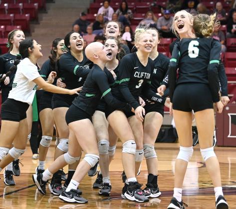 Lady Cubs rush the court following the match-winning point against Palmer Monday night in Hillsboro. Photo courtesy of Brett Voss’ The Sports Buzz