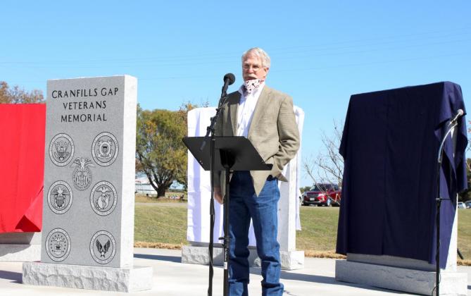 Above,Cranfills Gap Chamber of Commerce Ed Rieser speaks to the large crowd gathered together to celebrate the dedication of the newly erected memorial at Wade Lee Park in Cranfills Gap. Right, Bosque County residnets turned out in droves to witness the dedication on Veterans Day. Ashley Barner | Meridian Tribune