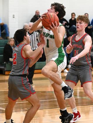 Clifton junior Jonah Payne (1) drives into the lane to make the shot (above); Junior Joaquin De la Hoya (2) fights for the rebound against Maypearl last Friday (left) Photos courtesy of Brett Voss’ The Sports Buzz