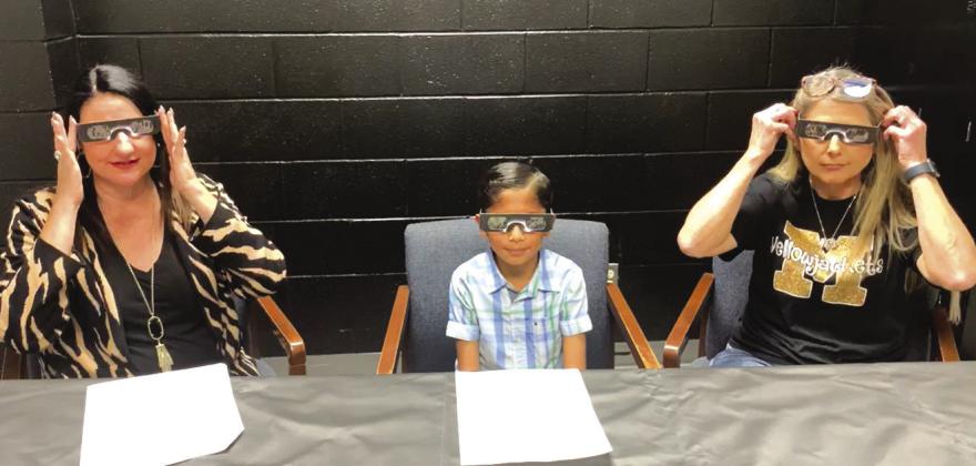 Meridian ISD Supt. Dana Davis, 4th grader Aaron Alonzo, and teacher Karla Childers demonstrate special safety glasses for the total solar eclipse during the district's Digital Dialogue on Tuesday, March 19. Courtesy Photo by Meridian ISD