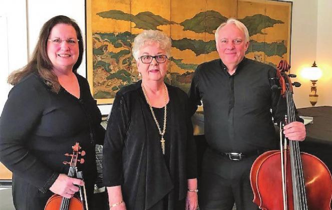 Photo feature, left to right, violinist Sharon Hawkins, pianist Judy Garwell, and cellist Todd Evans.