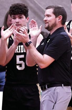 Jacket sophomore Matty Jones (10) drives for layup (right), senior Brady Taylor (5) and Meridian’s first-year head coach Grant Schur celebrate courtside at the conclusion of much-anticipated win over Morgan (left). Photos courtesy of Brett Voss’ The Sports Buzz