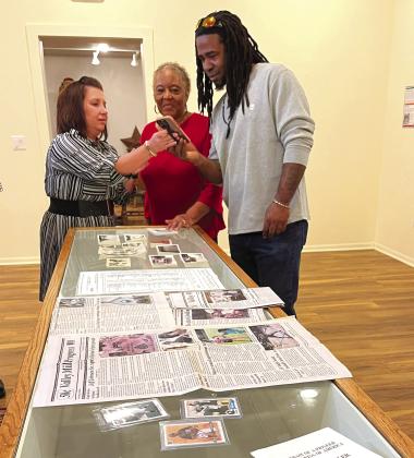 Stacy Sadler (from left) reviewed photos with Vivian Pollard and Ray Sadler at the opening reception of “Community: Black History in Bosque County,” a temporary exhibit at the Bosque Museum in Clifton on Wednesday, February 1, 2024. Nathan Diebenow | The Clifton Record