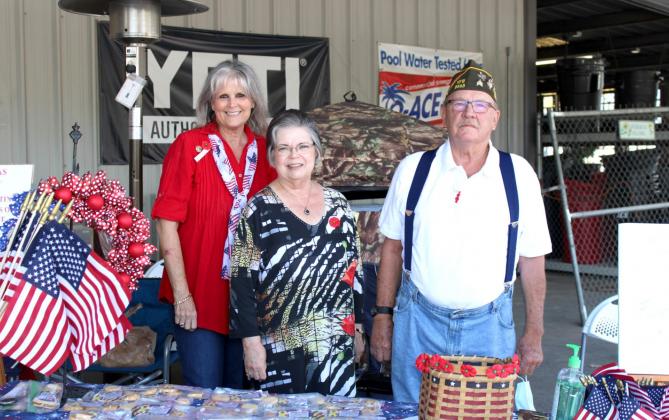 Left, NSDAR officers (from left) Carla Sigler and Sue Fielden work the table with Clifton VFW member Don Benda under the awning at Keith Ace Hardware Saturday in Clifton. Ashley Barner | The Clifton Record
